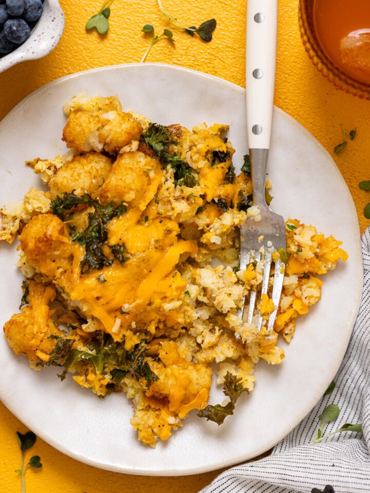 Up close shot of plate with baked tater tot casserole with a fork.