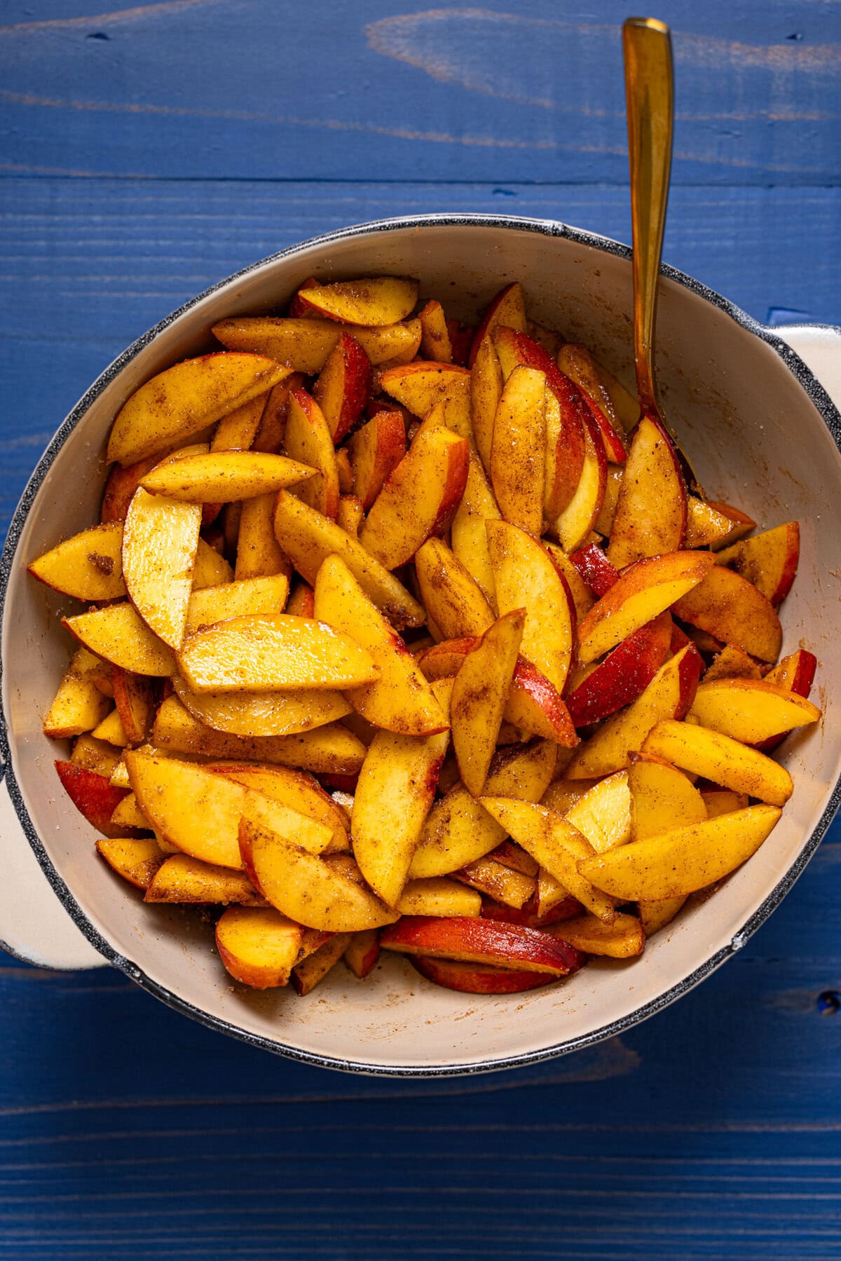 Peach filling in a bowl with a spoon.