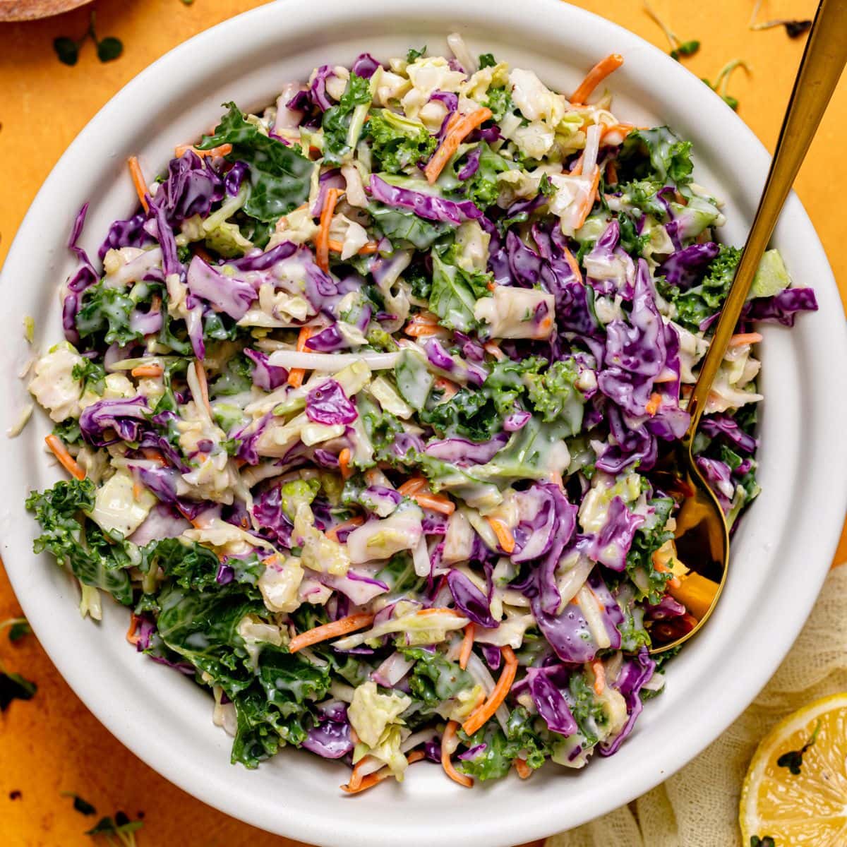 Coleslaw in a bowl with a spoon.