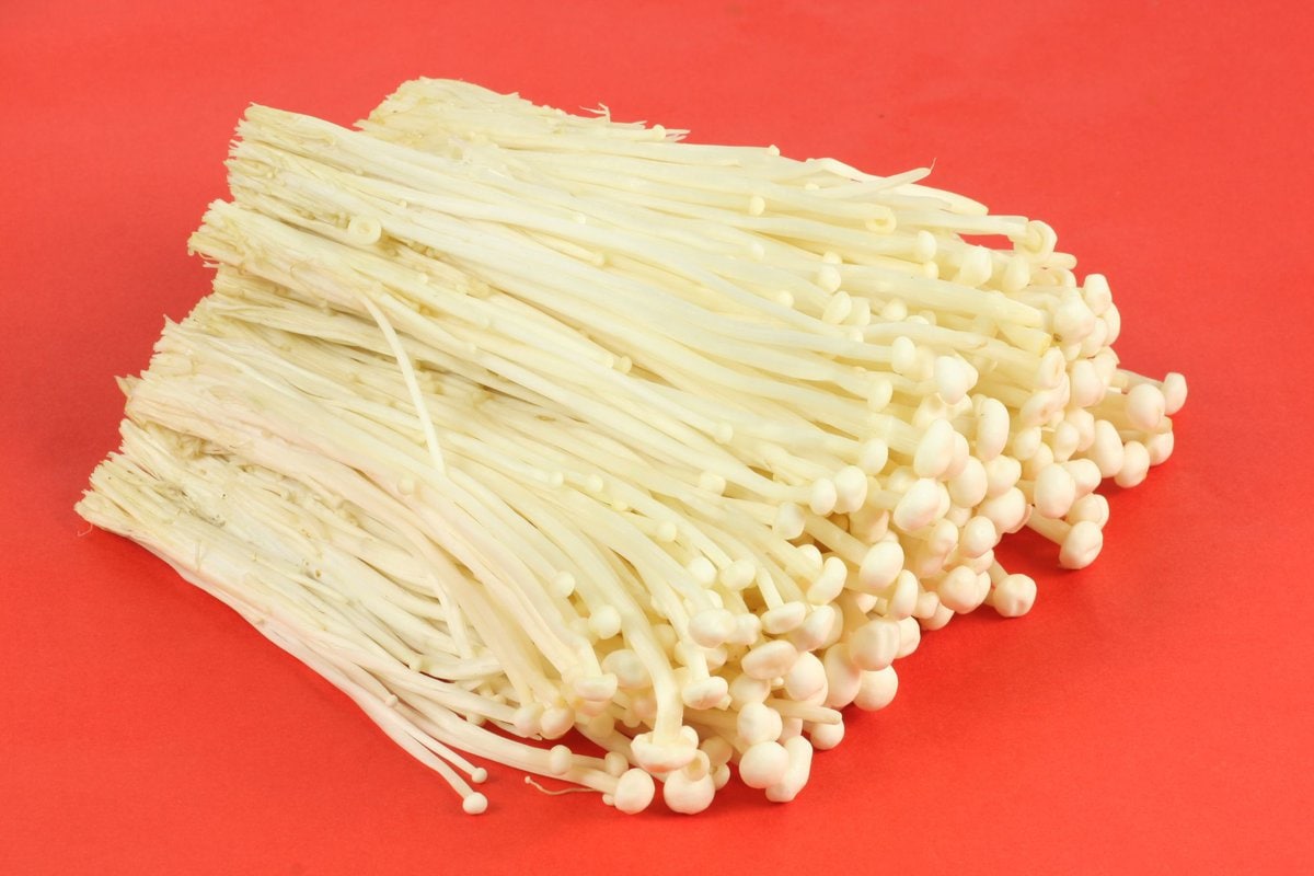 Bunch of enoki with red background.