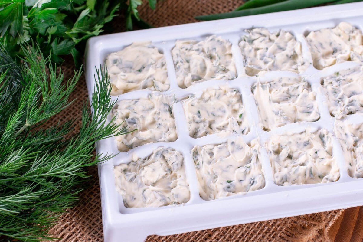 Herbs with butter in ice cube tray.