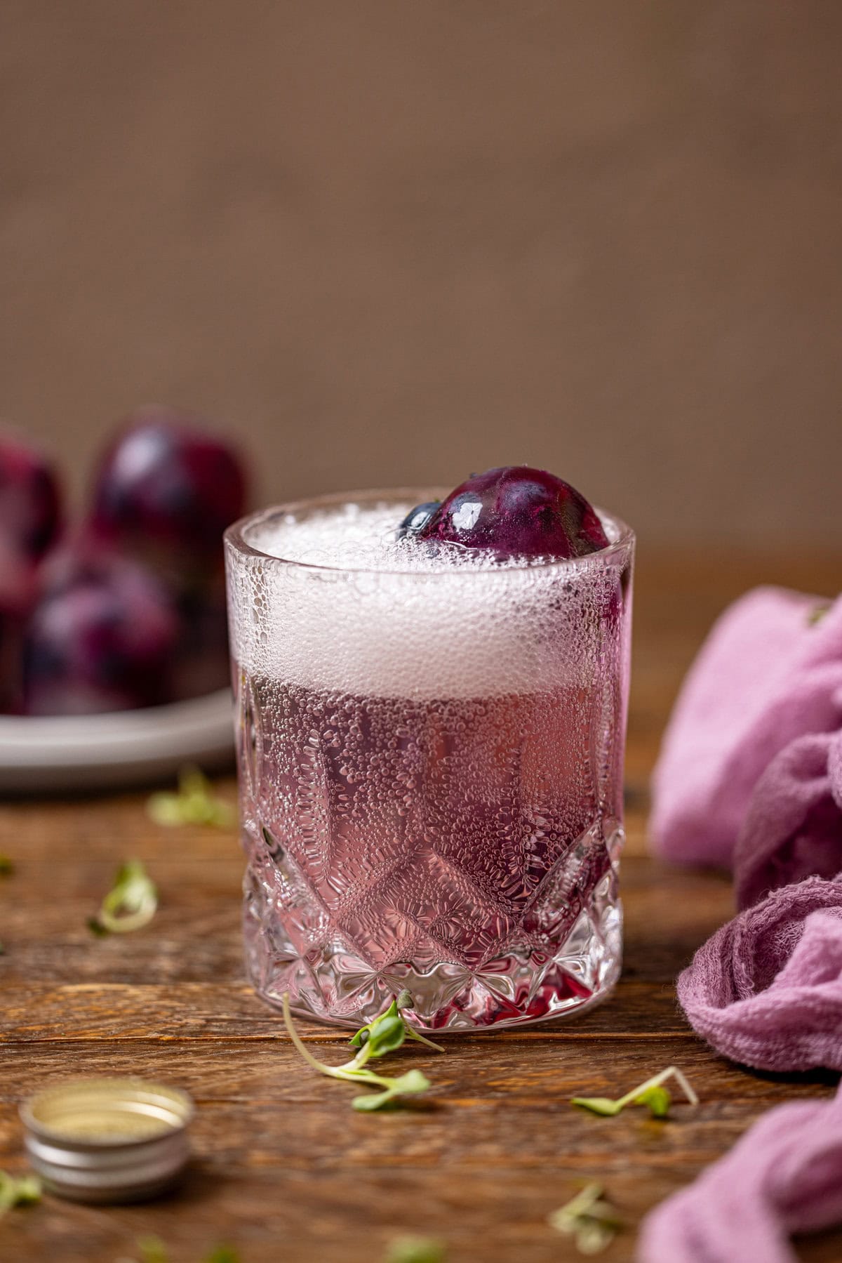 Blueberry lemonade thyme ice cubes in a glass with a soda.