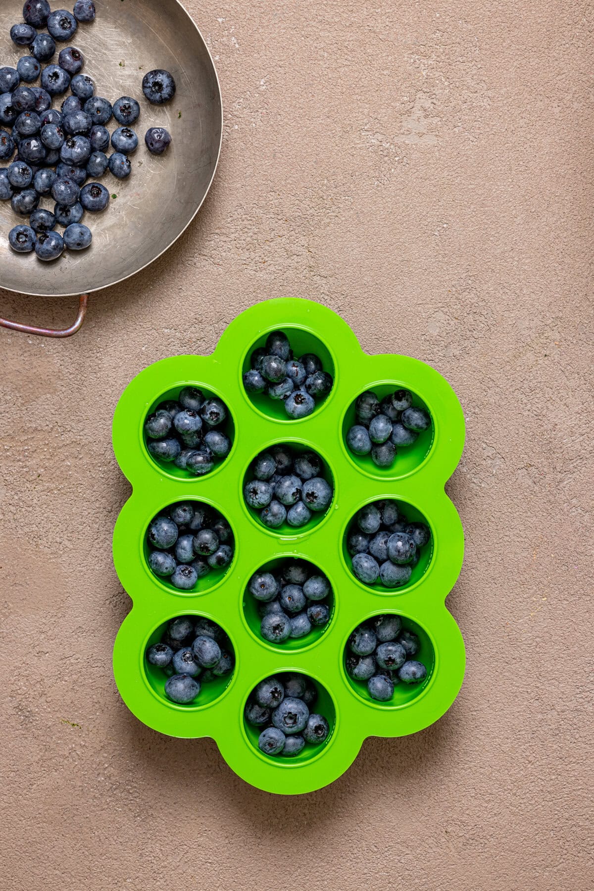 Blueberries in ice cube cavities. 