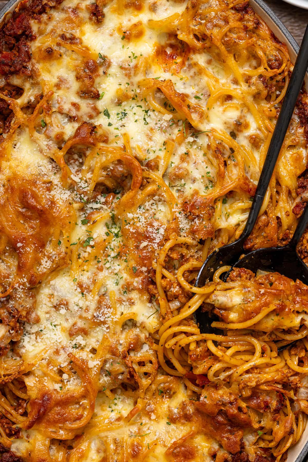 Up close shot of baked spaghetti with a spoon.