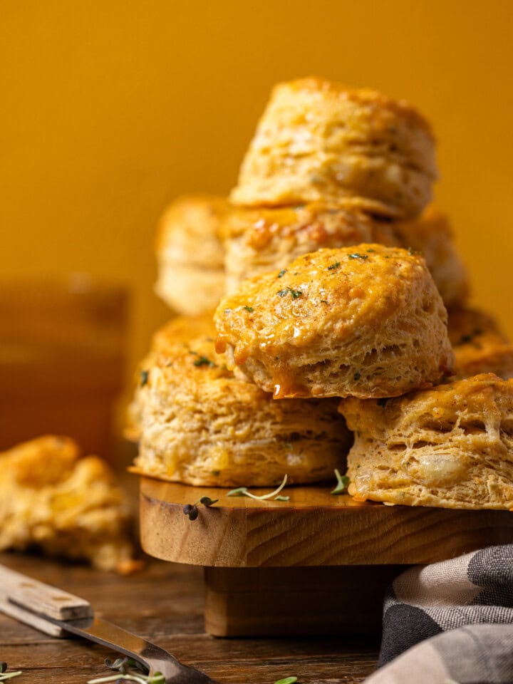 Up close shot of stacked biscuits on a wood platter.