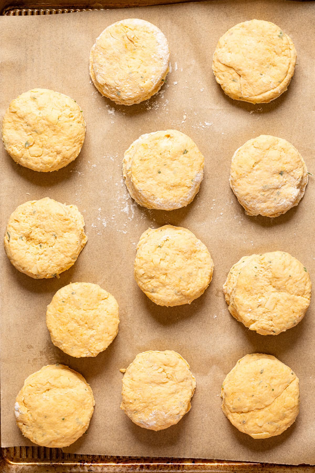 Cut out biscuit dough on a baking sheet with parchment paper.