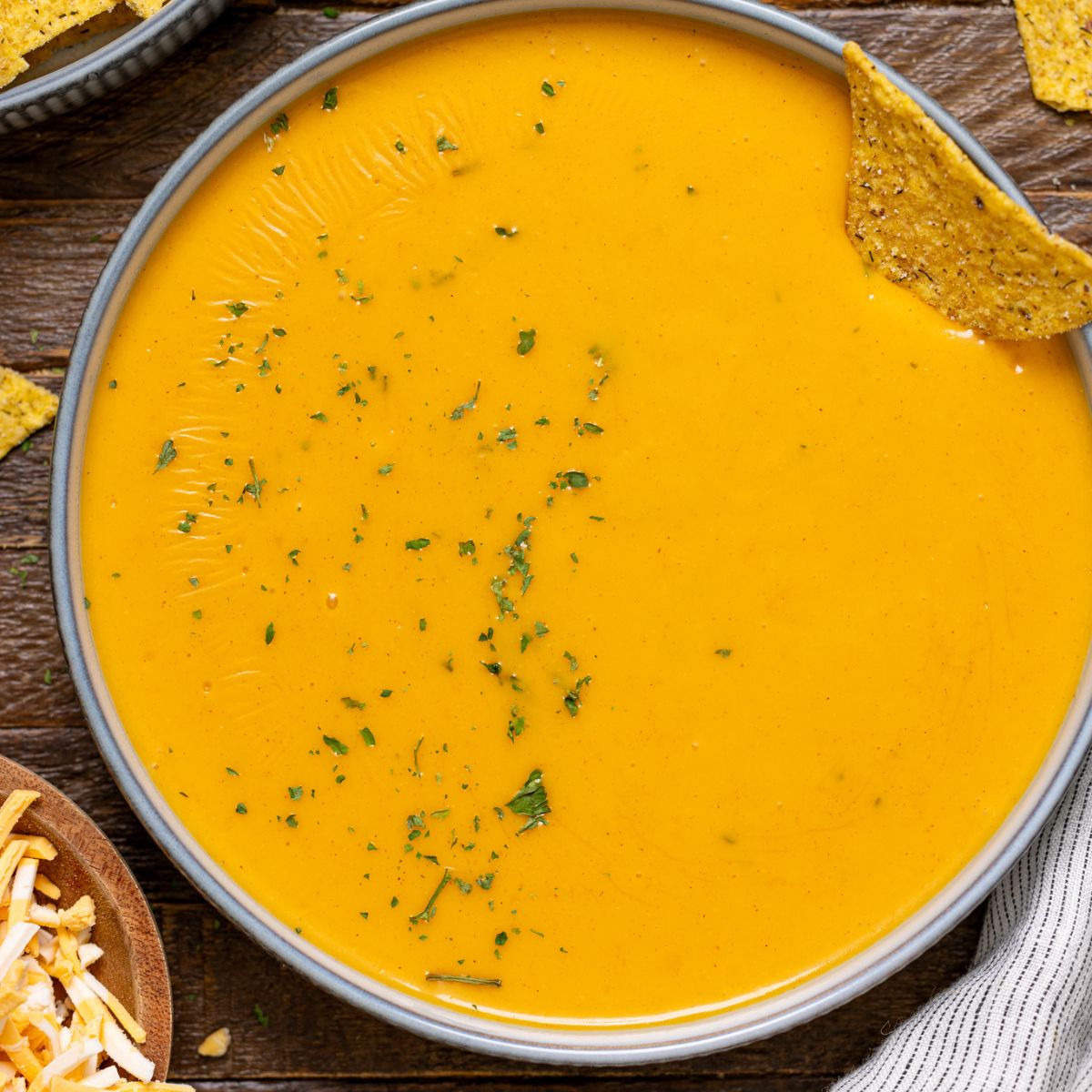 Up close shot of nacho cheese in a bowl.