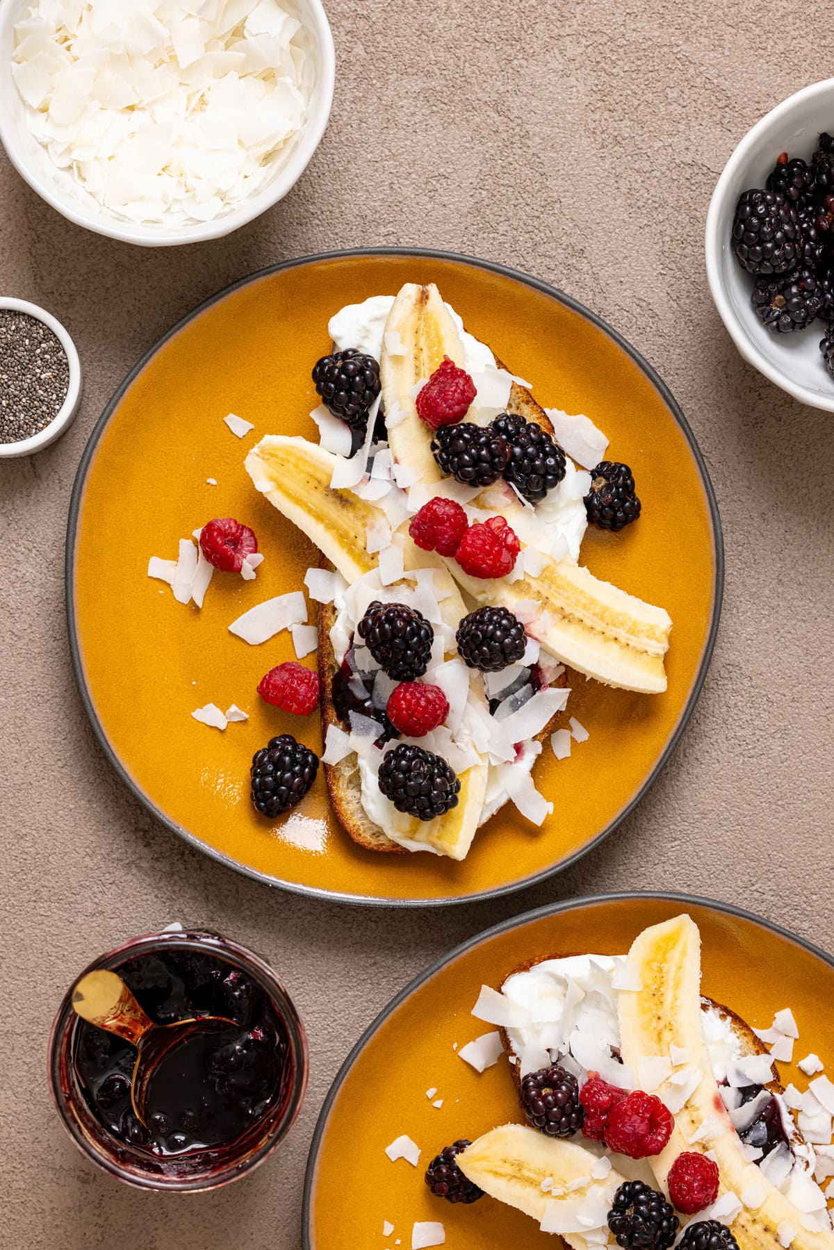 Breakfast toast on two plates with ingredients.