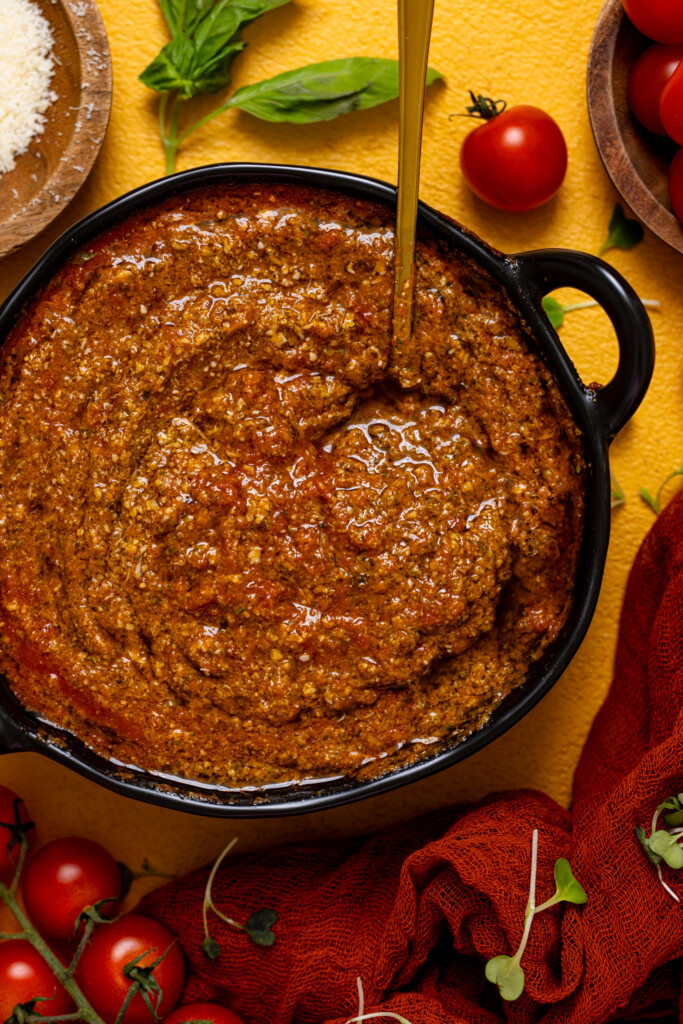 Up close shot of tomato pesto sauce in a bowl.