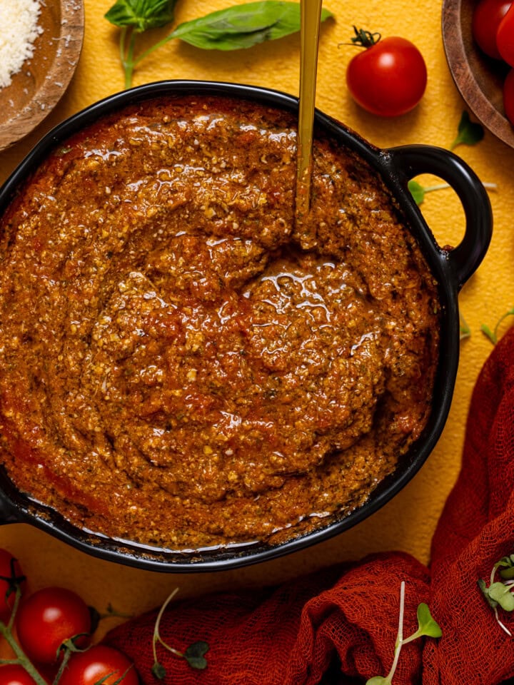 Up close shot of tomato pesto sauce in a bowl.