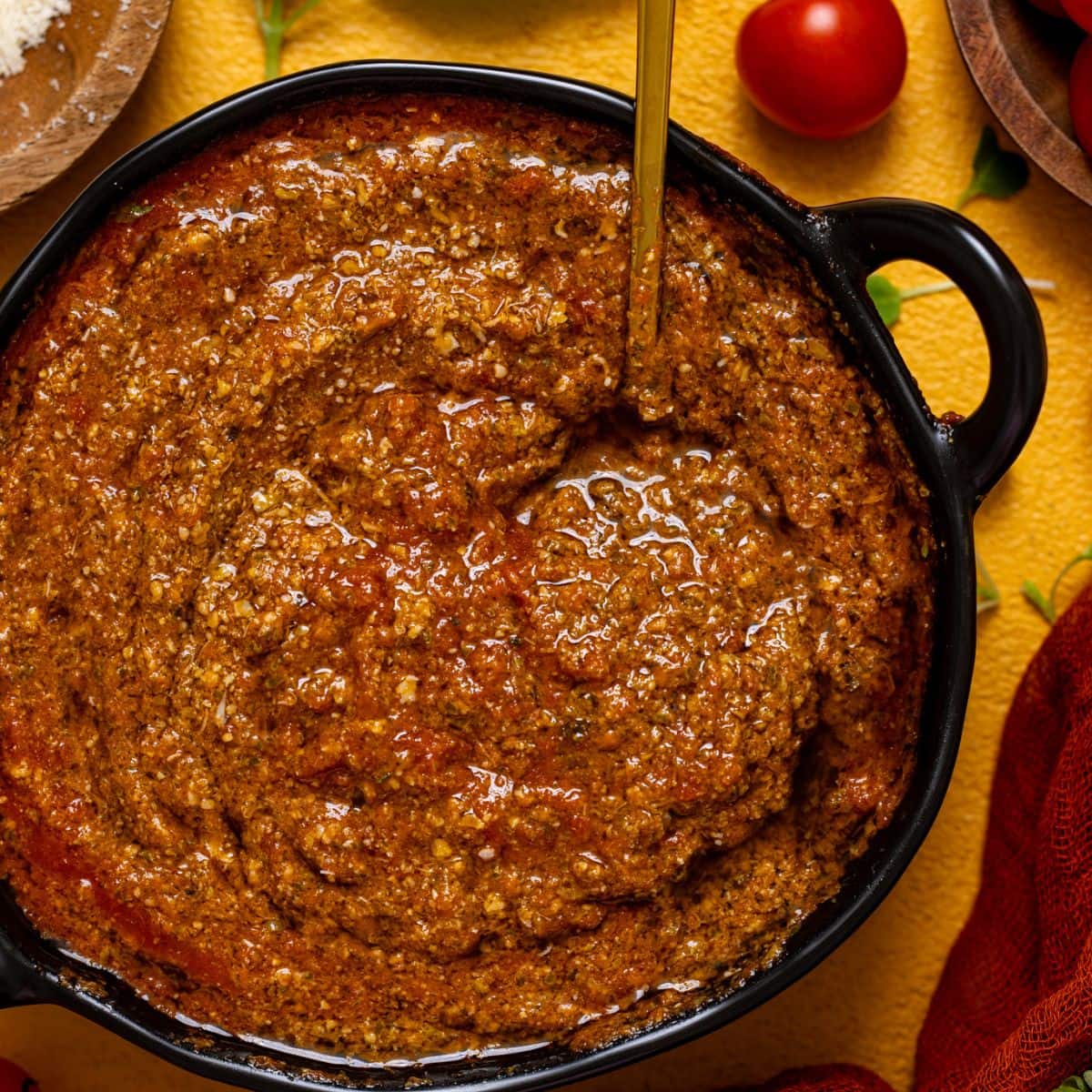 Up close shot of tomato pesto sauce in a bowl.