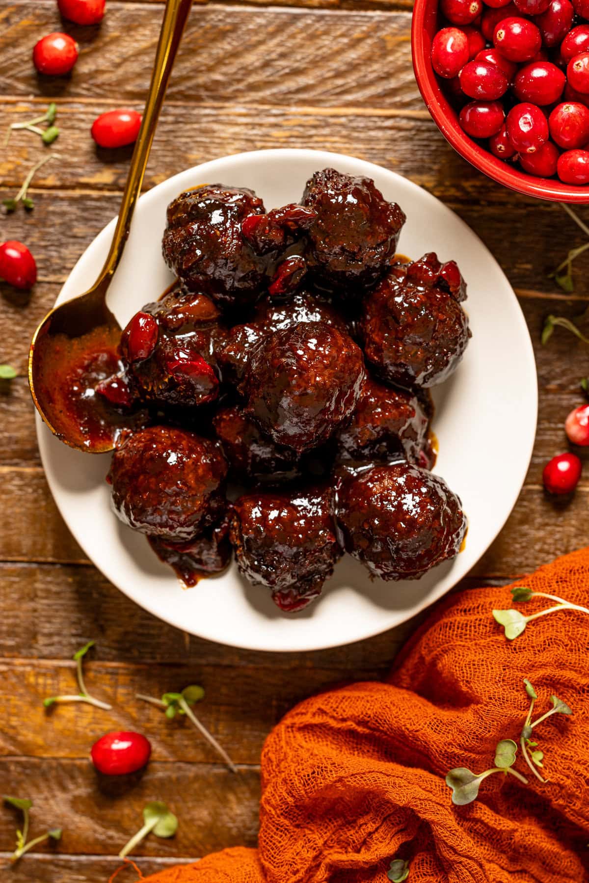 BBQ Jerk meatballs on a white plate with a spoon.