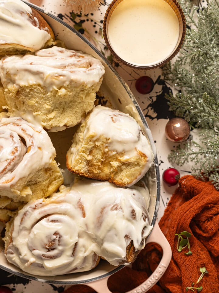 Up close shot of Eggnog cinnamon rolls in a baking dish.