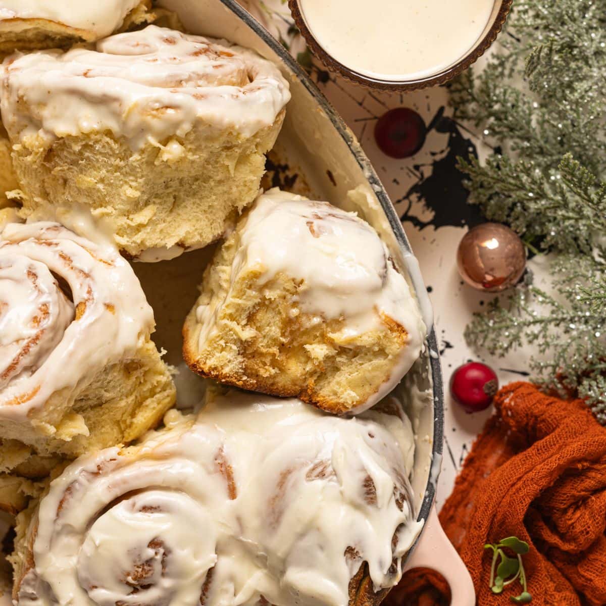 Up close shot of Eggnog cinnamon rolls in a baking dish.