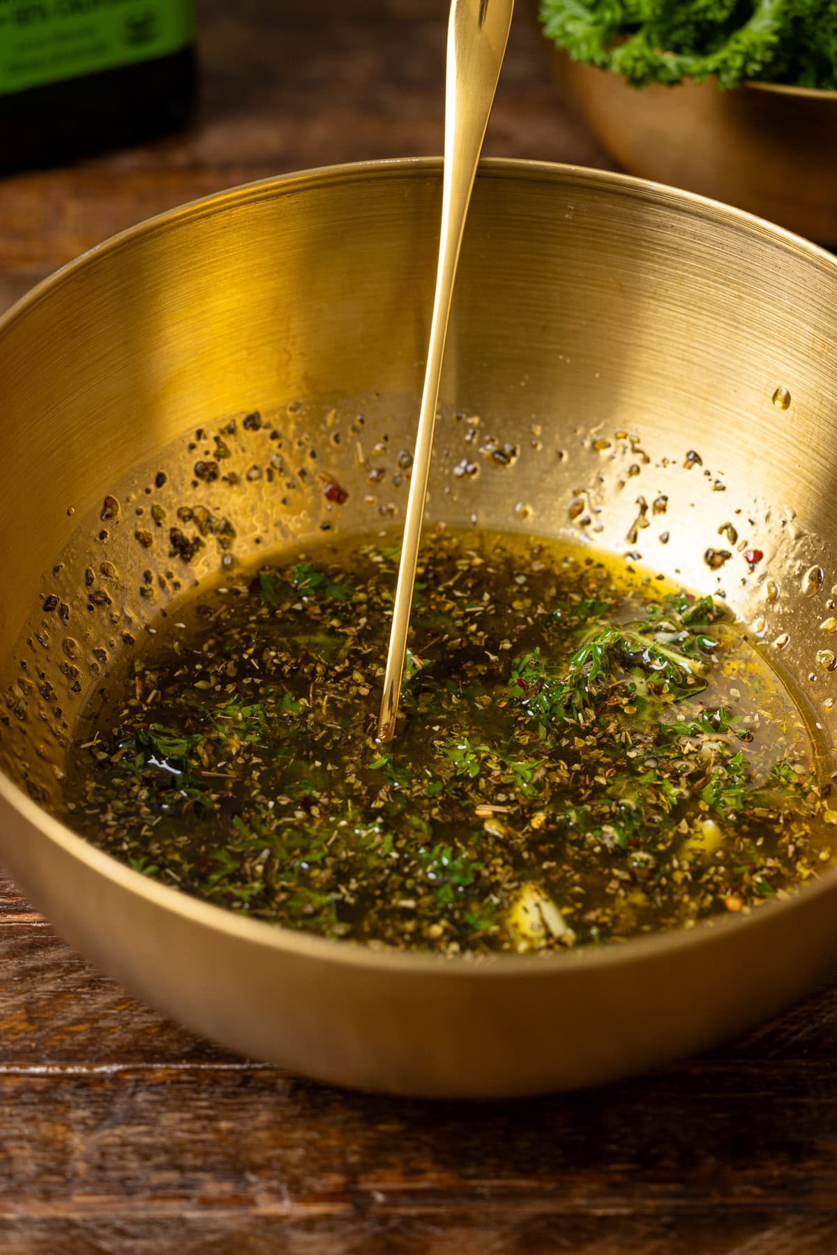 Ingredients in a gold bowl with a spoon.