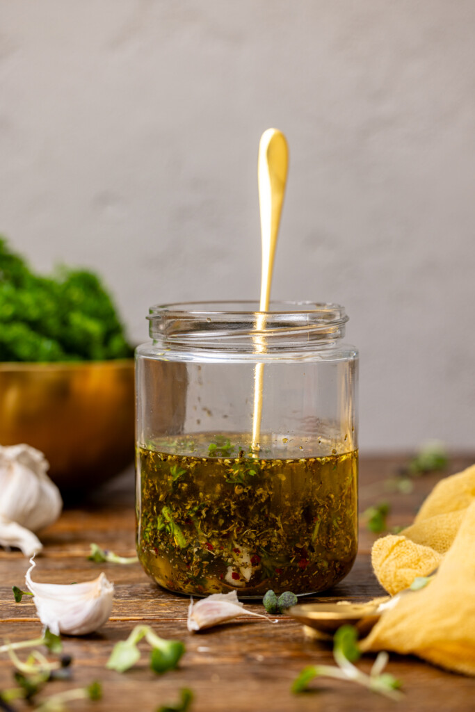 Dressing in a mason jar with a spoon.