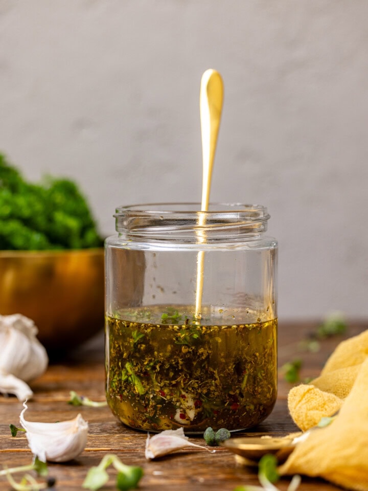 Dressing in a mason jar with a spoon.