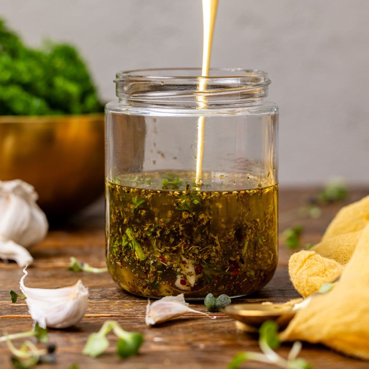 Dressing in a mason jar with a spoon.