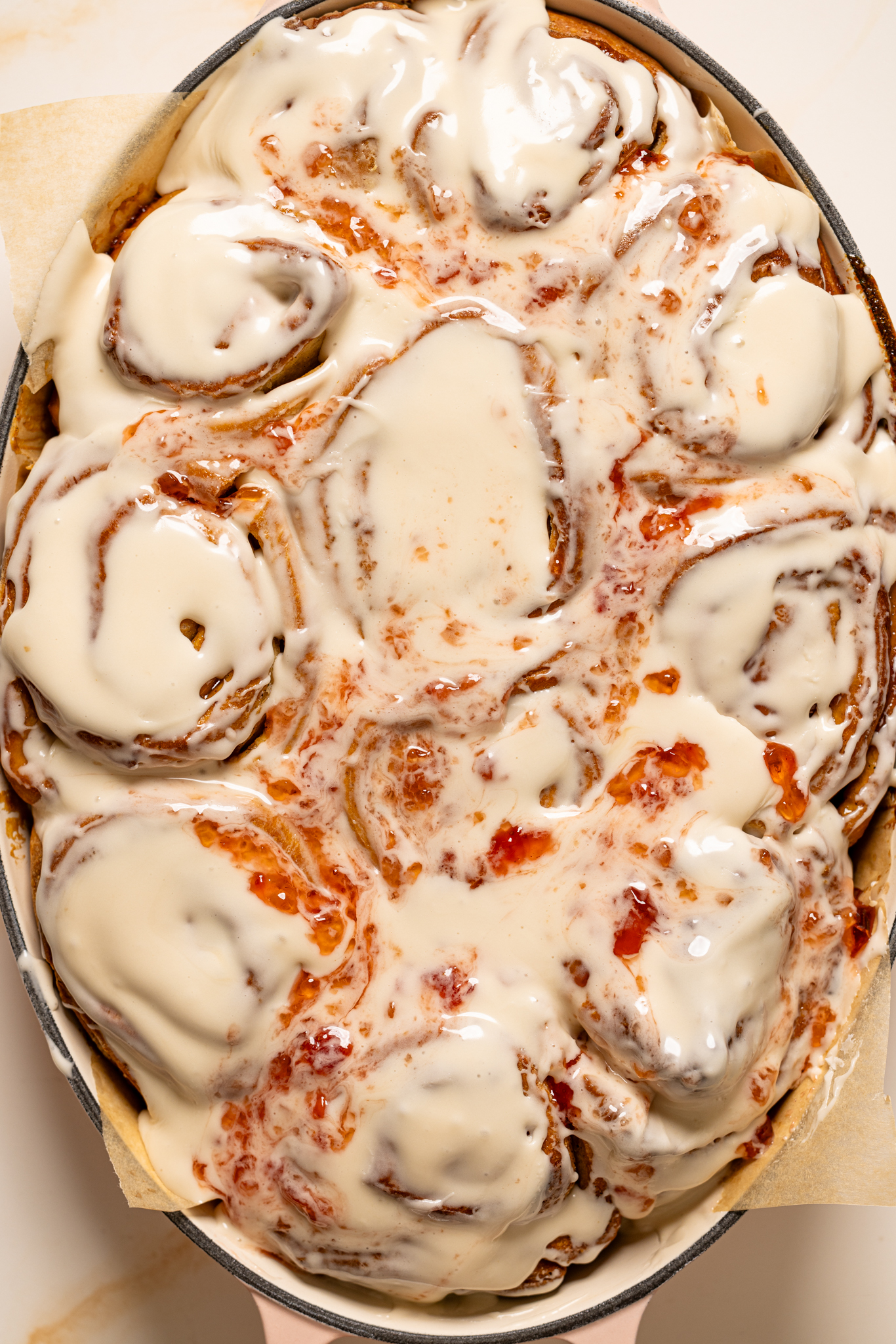 Cinnamon rolls glazed in a baking dish.